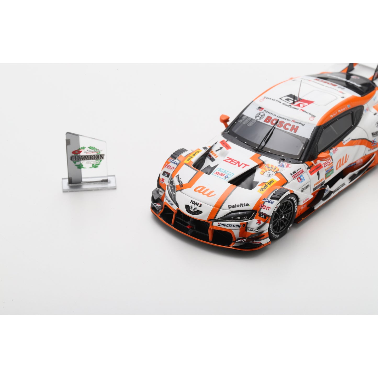 Spark 43SGT2025 1:43 - Toyota GR Supra TGR TEAM at TOM'S No.1 GT500 Class Champion SUPER GT 2025 S. Tsuboi - K. Yamashita with Champion board