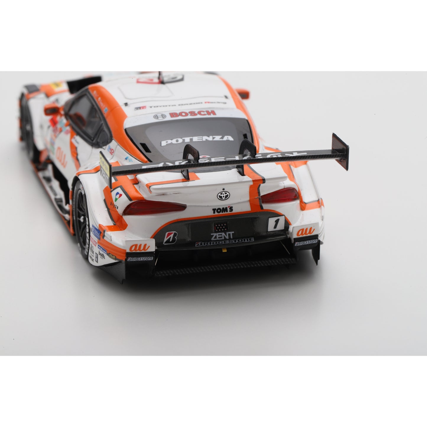 Spark 43SGT2025 1:43 - Toyota GR Supra TGR TEAM at TOM'S No.1 GT500 Class Champion SUPER GT 2025 S. Tsuboi - K. Yamashita with Champion board